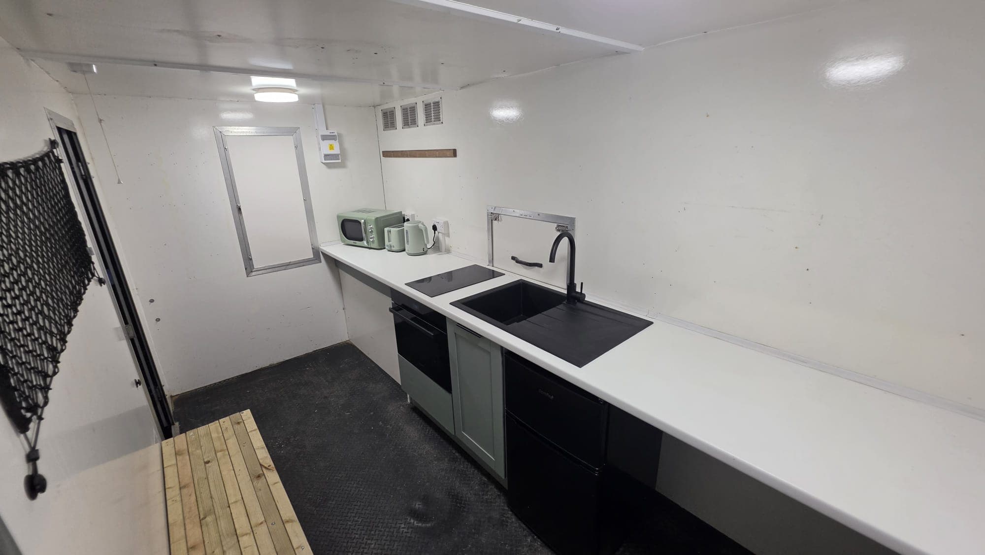 Angled view of the kitchen run, from the entrance towards the sink.